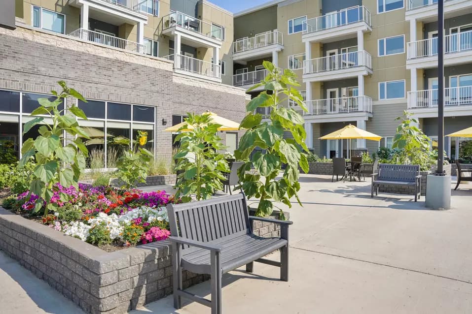 beautiful courtyard with lush gardens at chartwell heritage valley retirement residence
