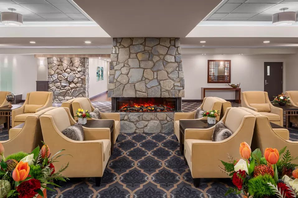 cozy and warm fireside lounge at chartwell fountains of mission retirement residence