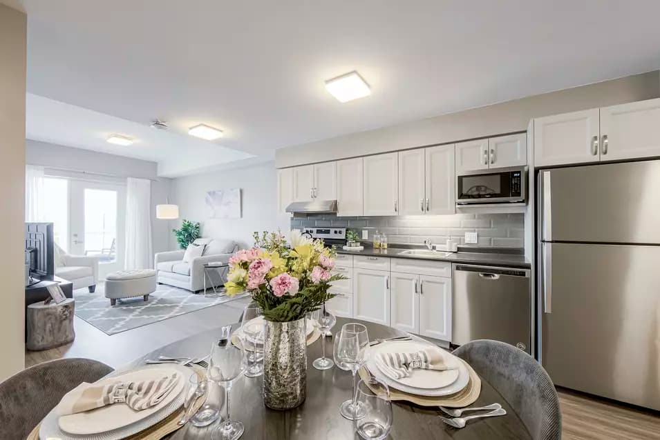 chartwell montgomery village, suite, kitchen, dining room, living room, studio, table, chairs, place settings, fridge, sofa chair, tv